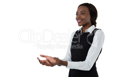 Smiling woman gesturing against white background
