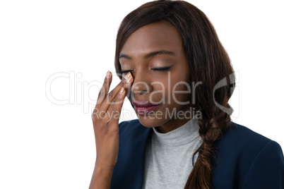 Close up of businesswoman rubbing eyes