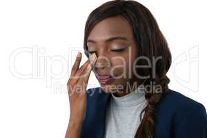 Close up of businesswoman rubbing eyes