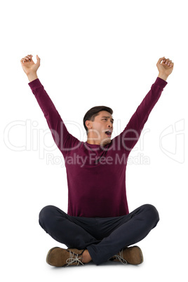Businessman with arms raised yawning