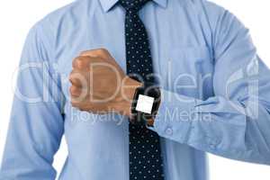 Mid section of businessman showing smartwatch