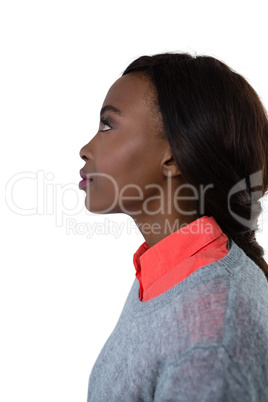 Side view of thoughtful young woman looking up