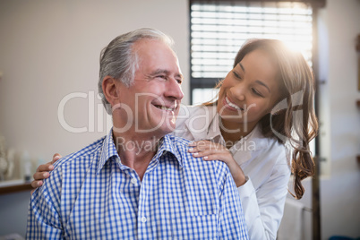 Smiling therapist and male patient looking at each other