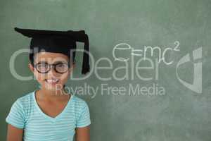 Young girl with graduation hat against chalk board