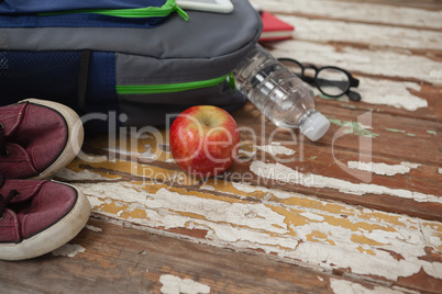 Bagpack, water bottle, apple, shoes and spectacle