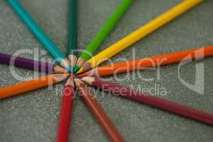 Various color pencils arranged on chalkboard