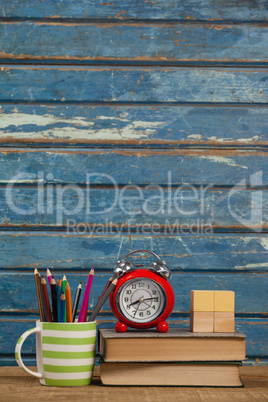 Alarm clock , books, paperweight and pen holder