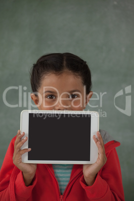 Young girl holding digital tablet against her face