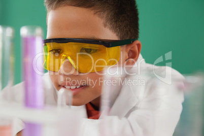 Schoolboy experimenting against green background