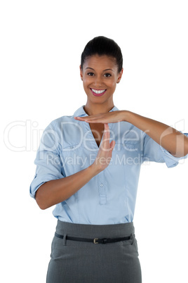 Smiling businesswoman making a timeout hand gesture