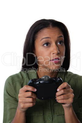 Woman playing video game against white background