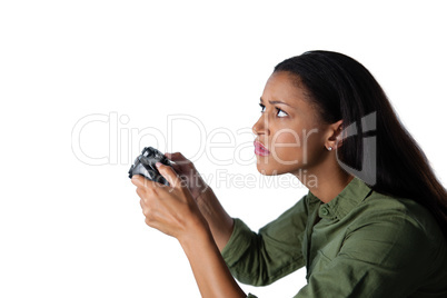 Woman playing video game against white background