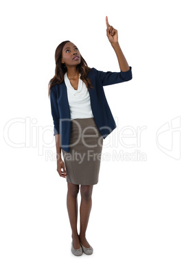 Full length of businesswoman pointing upwards