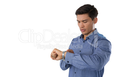 Young businessman looking at time