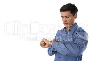 Young businessman looking at time