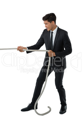 Full length of businessman pulling rope