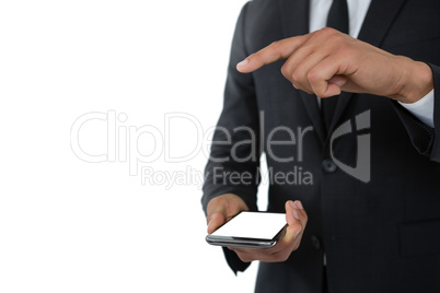 Mid section businessman gesturing while holding mobile phone
