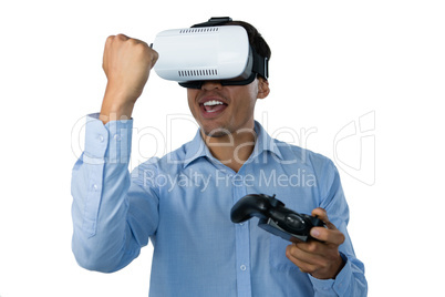 Happy businessman with vr glasses clenching fist while playing video game