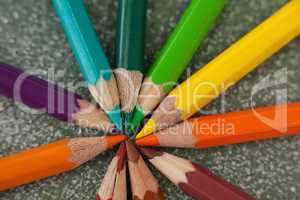 Various color pencils arranged on chalkboard