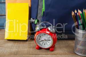 Bagpack, books, alarm clock and pen holder