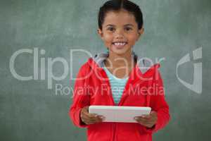 Young girl holding digital tablet