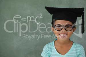 Young girl with graduation hat against chalk board