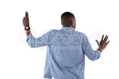 Man pretending to touch an invisible screen against white background