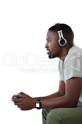 Man playing video game against white background