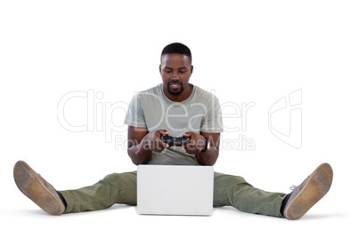 Man playing video game on laptop