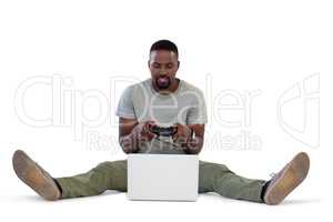 Man playing video game on laptop