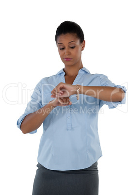 Businesswoman looking at her wristwatch