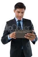 Happy businessman using tablet