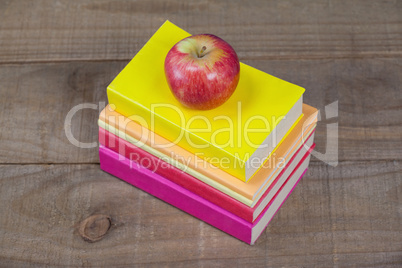 Stack of books and apple