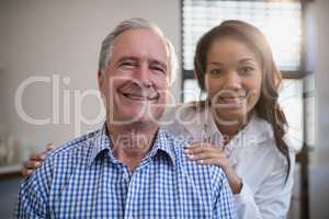 Portrait of smiling female therapist and senior male patient