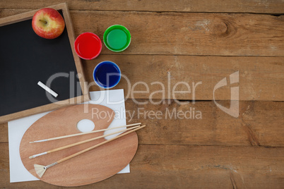 Slate, chalk, apple, watercolors, brush and water pallete