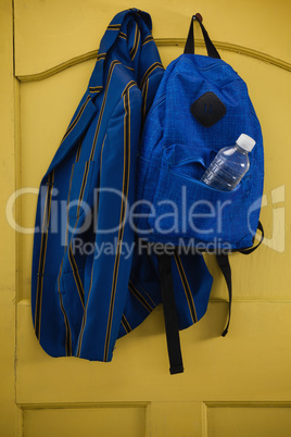 School uniform and bag hanging on door