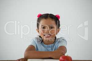 Young girl sitting on her desk