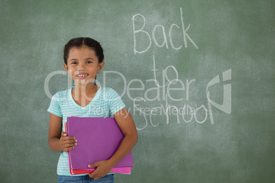 Young girl holding books