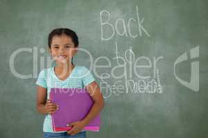 Young girl holding books