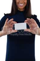 Female executive holding a blank business card