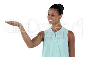 Businesswoman making hand gesture while presenting