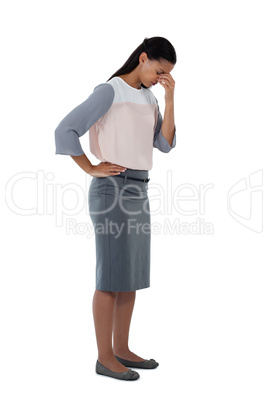 Stressed businesswoman standing with her head down