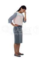 Stressed businesswoman standing with her head down
