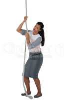 Businesswoman climbing the rope