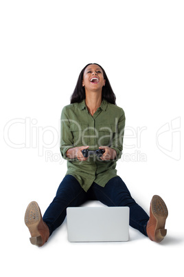 Woman playing video game on laptop against white background