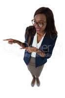 Smiling businesswoman gesturing while giving presentation