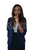 Portrait of businesswoman with finger on lips