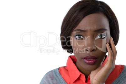 Portrait of surprised young woman with hand on chin