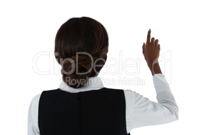 Rear view of businesswoman touching invisible interface
