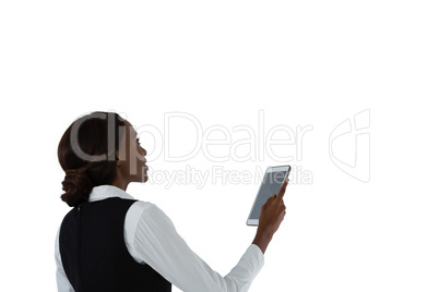 Side view of woman using tablet computer